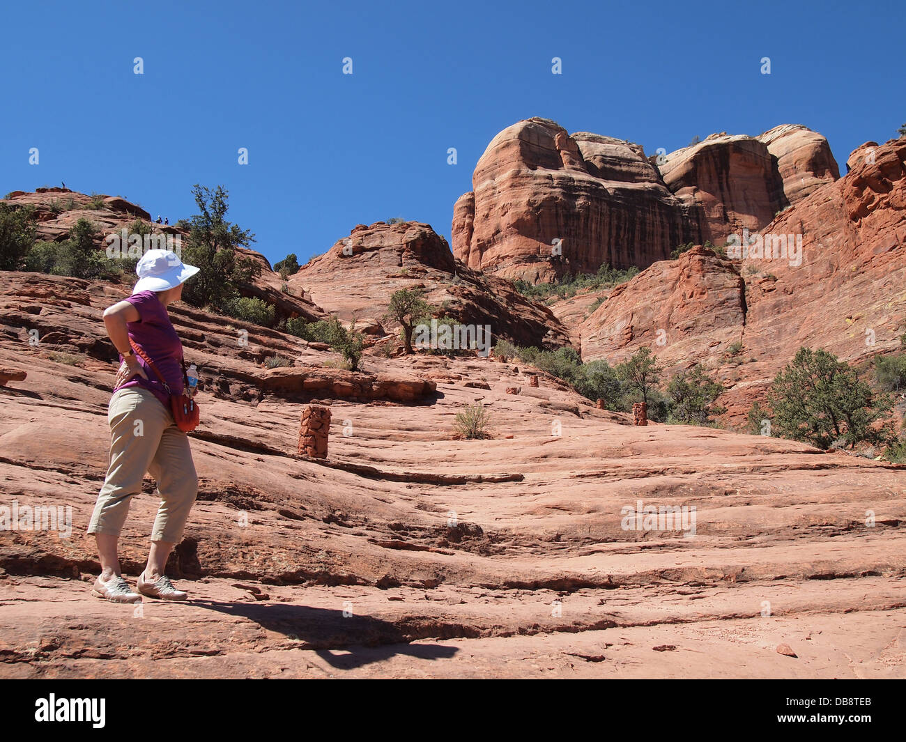 Woman tourist hikes at Cathedral Rock, a magnetic (feminine) energy vortex, in Sedona, Arizona, USA Stock Photo