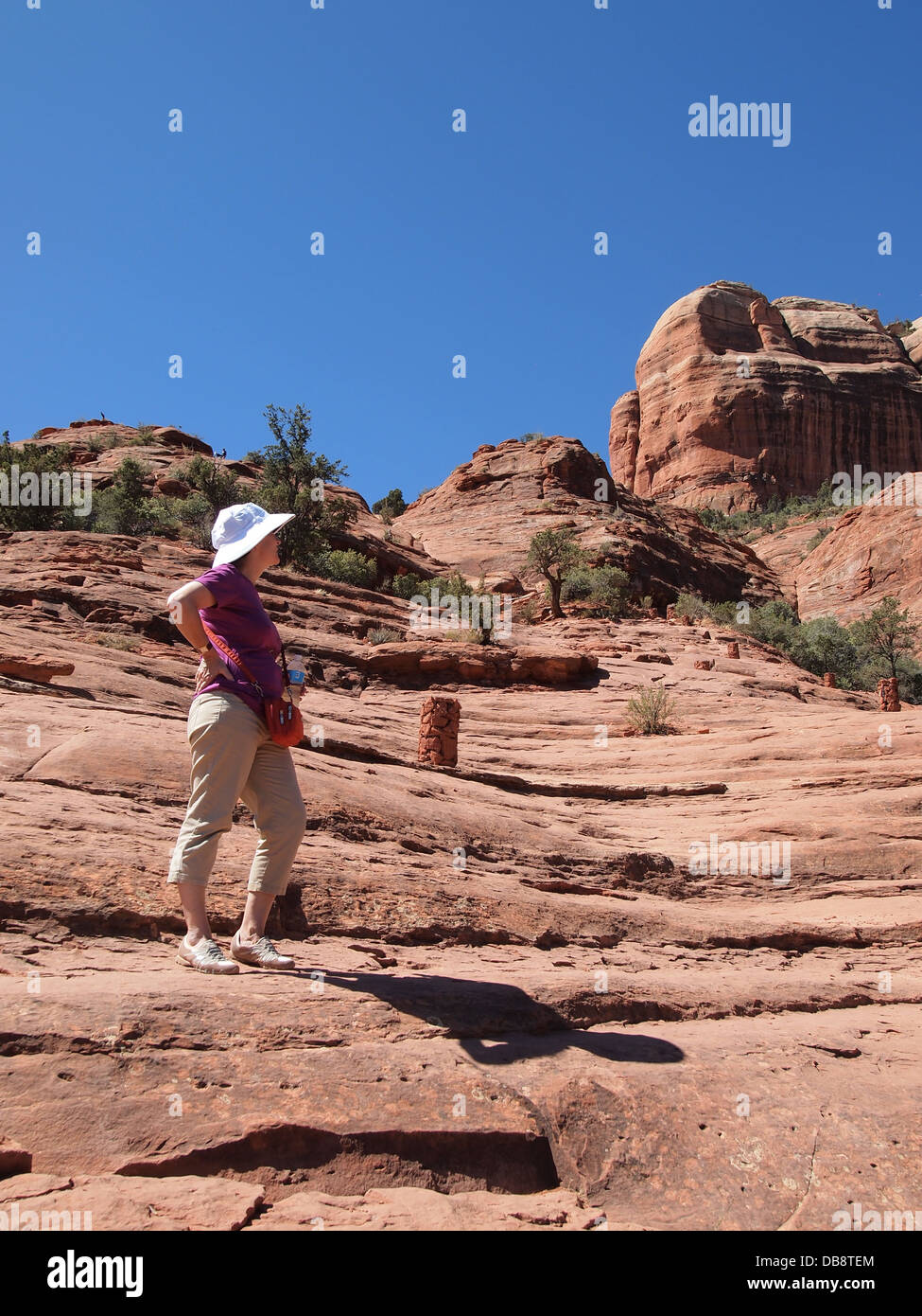 Woman tourist hikes at Cathedral Rock, a magnetic (feminine) energy vortex, in Sedona, Arizona, USA Stock Photo