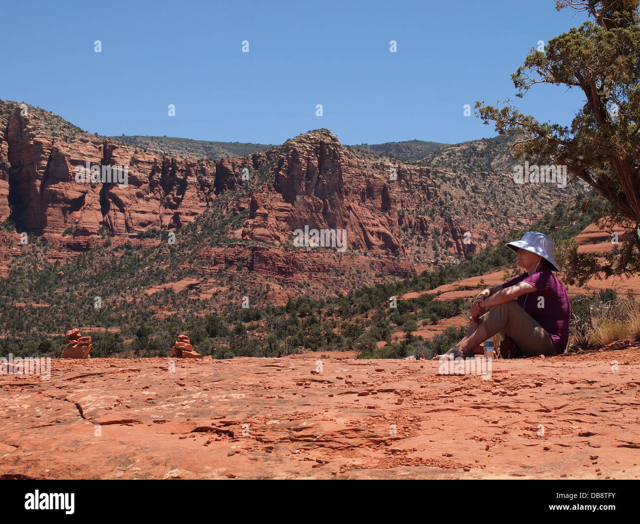 Woman tourist rests during a hike at Belll Rock, a balanced (both masculine and feminine) energy vortex, in Sedona, Arizona, USA Stock Photo