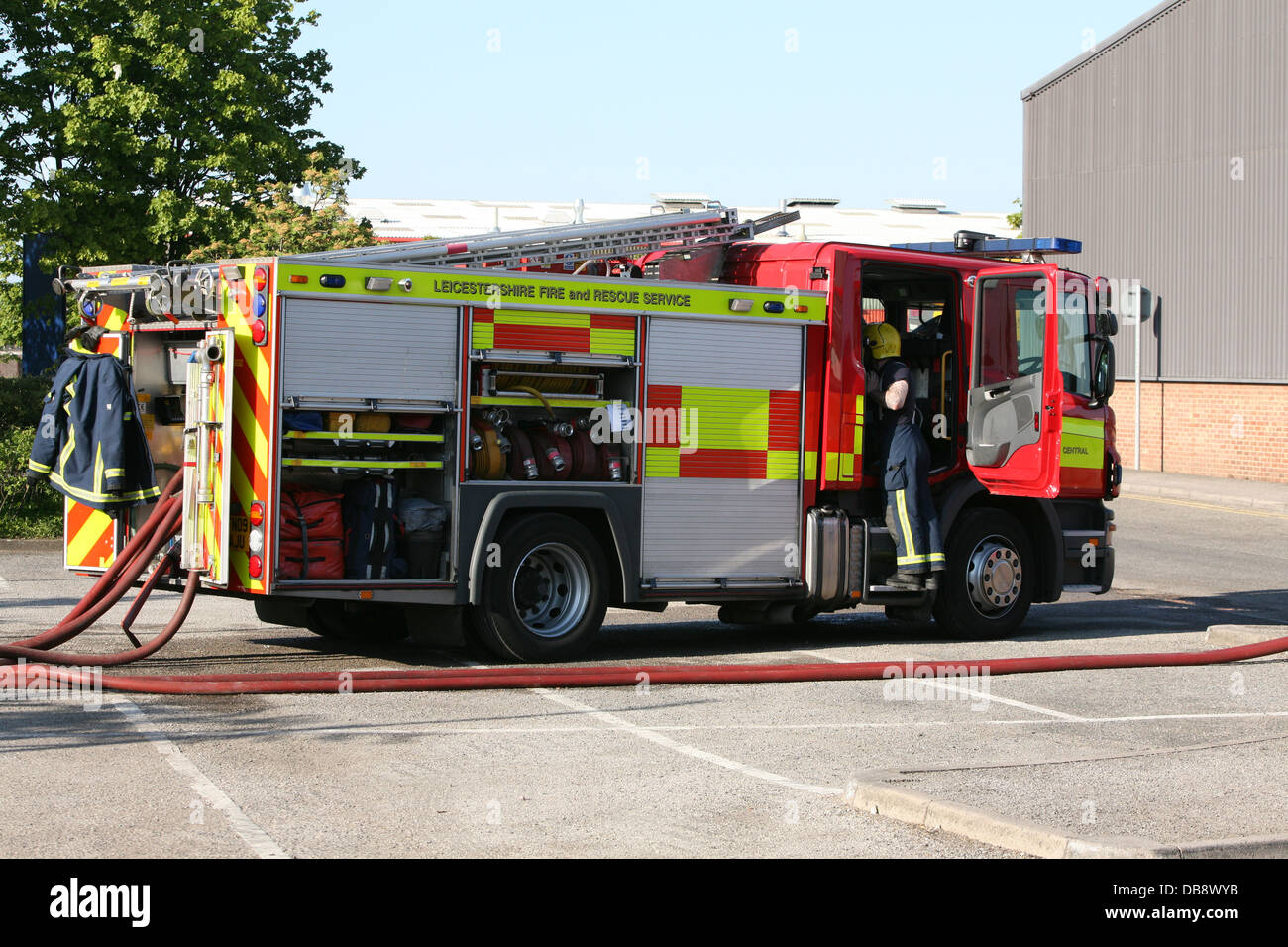 fire engine and firefighter at scene of a fire Stock Photo
