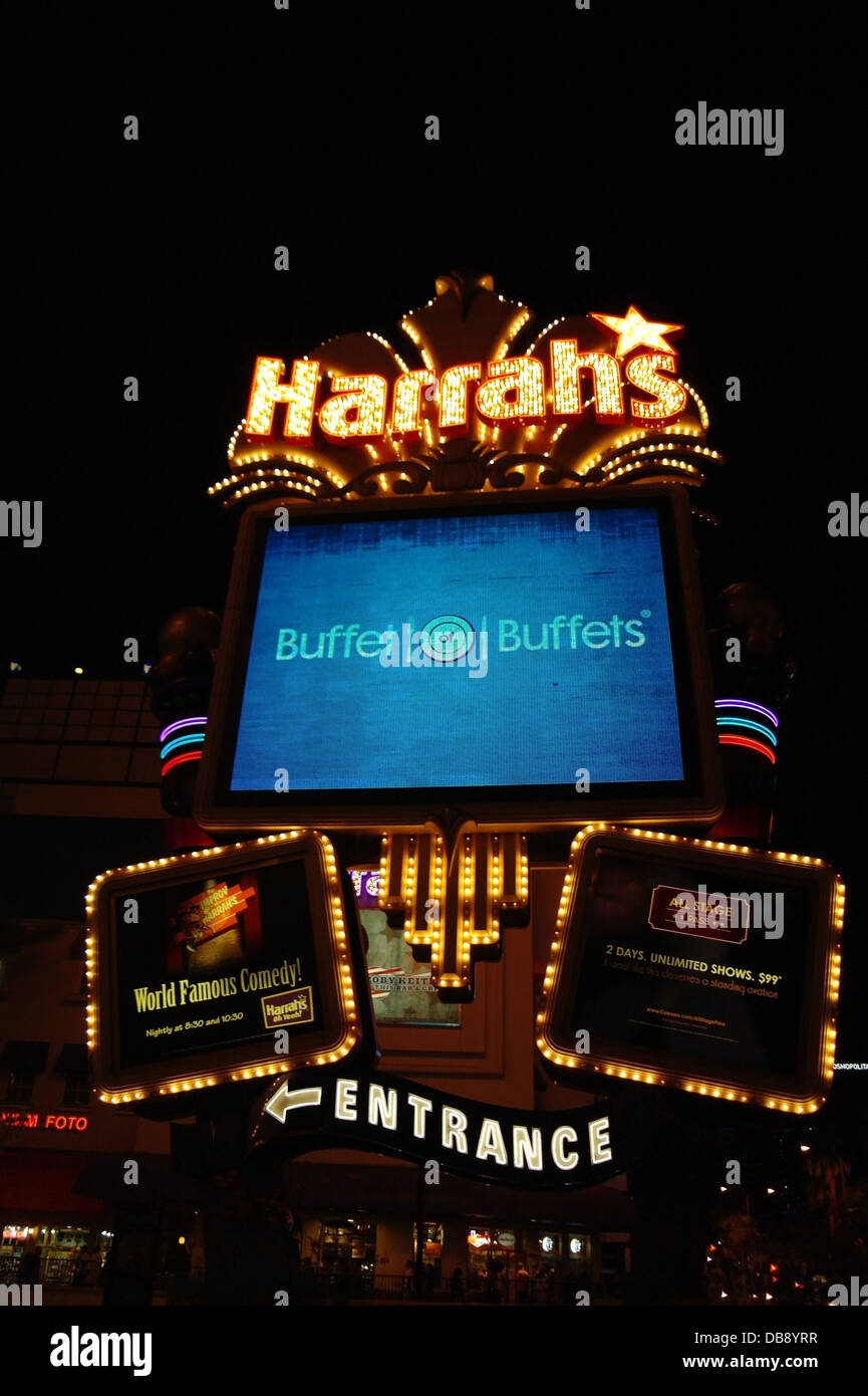 Sign 1 tall yellow neon harrahs name rising centre foreground hires