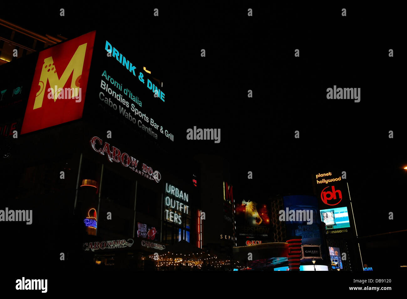 Night view neon electronic billboards ('Cabo Wabo Cantina' 'Urban Outfitters'),  Planet Hollywood Casino, Las Vegas Strip, USA Stock Photo