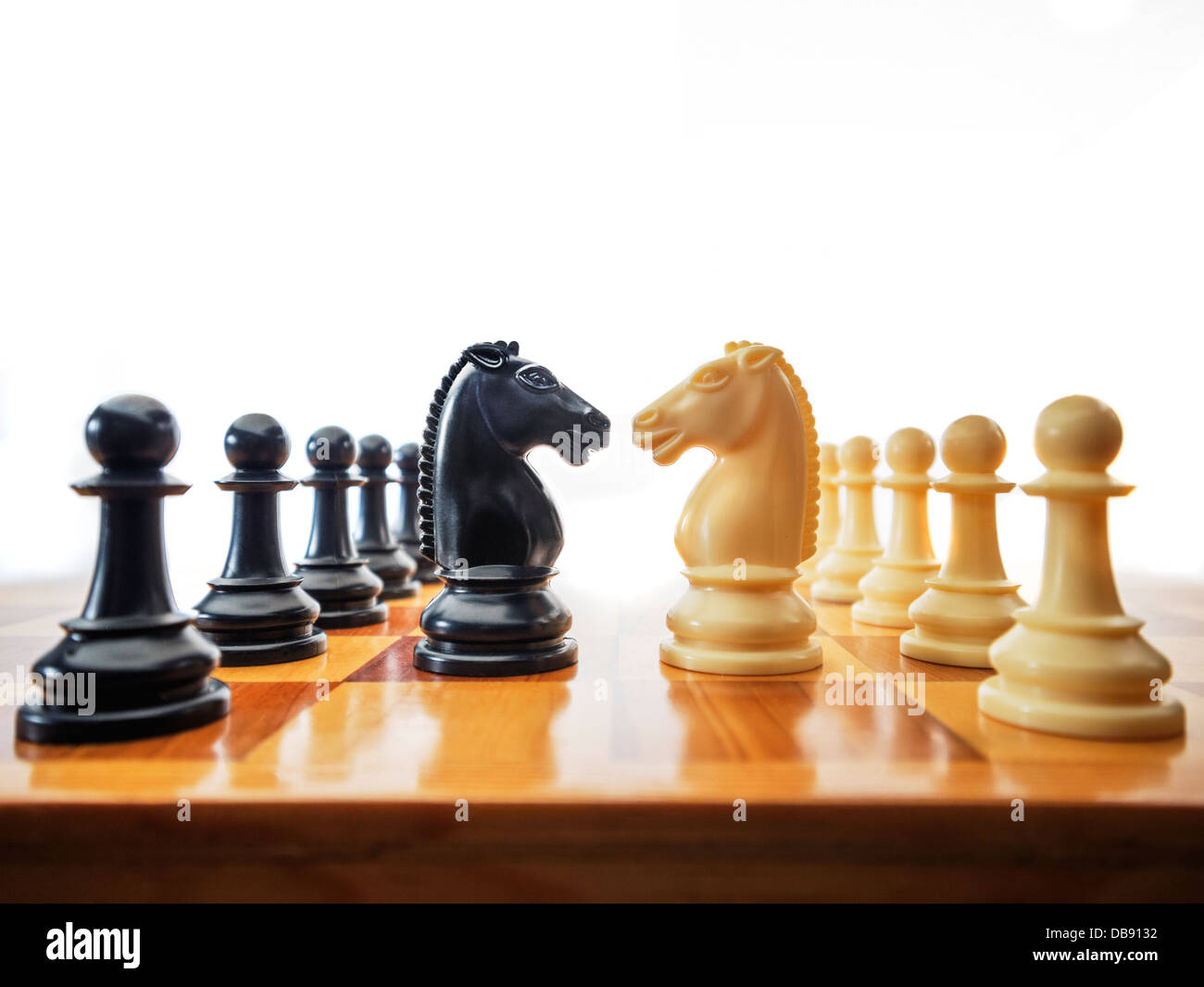 Chess pieces facing off as a metaphor for business and war Stock Photo