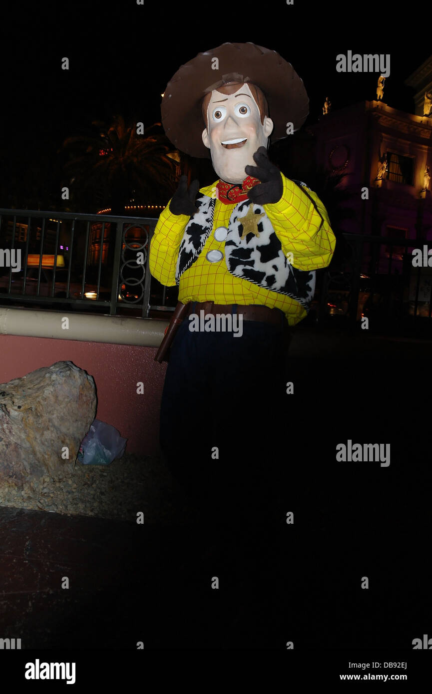 Night flashlight portrait street entertainer dressed as Toy Story Woody the Cowboy, sidewalk near Harrah's Sign, Las Vegas Strip Stock Photo