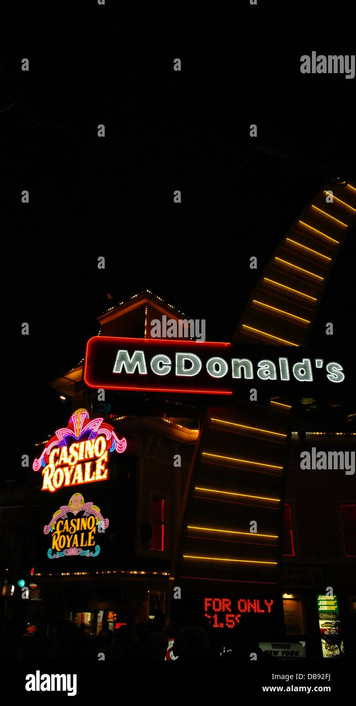 Black sky night neon portrait tall McDonald's Sign rising sidewalk towards Casino Royale, Las Vegas Strip, USA Stock Photo