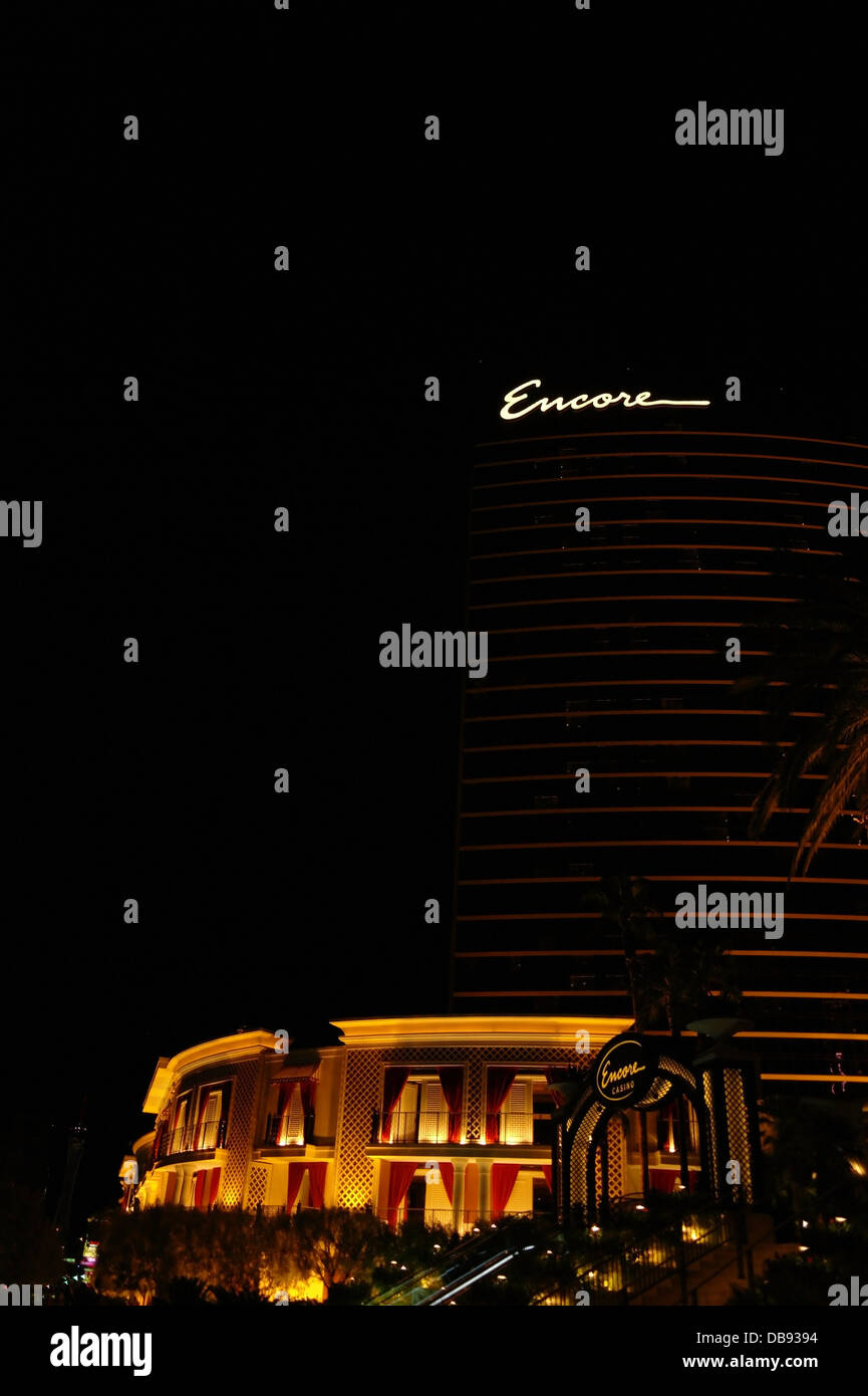 Night portrait electric lights Encore Resort hotel tower rising above tiered garden stairs to Encore Casino, Las Vegas Strip, US Stock Photo