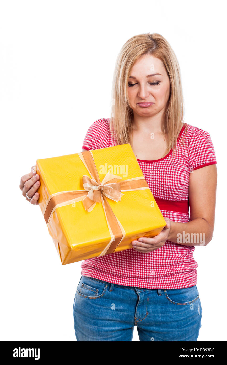 Disappointed woman holding present, isolated on white background. Stock Photo