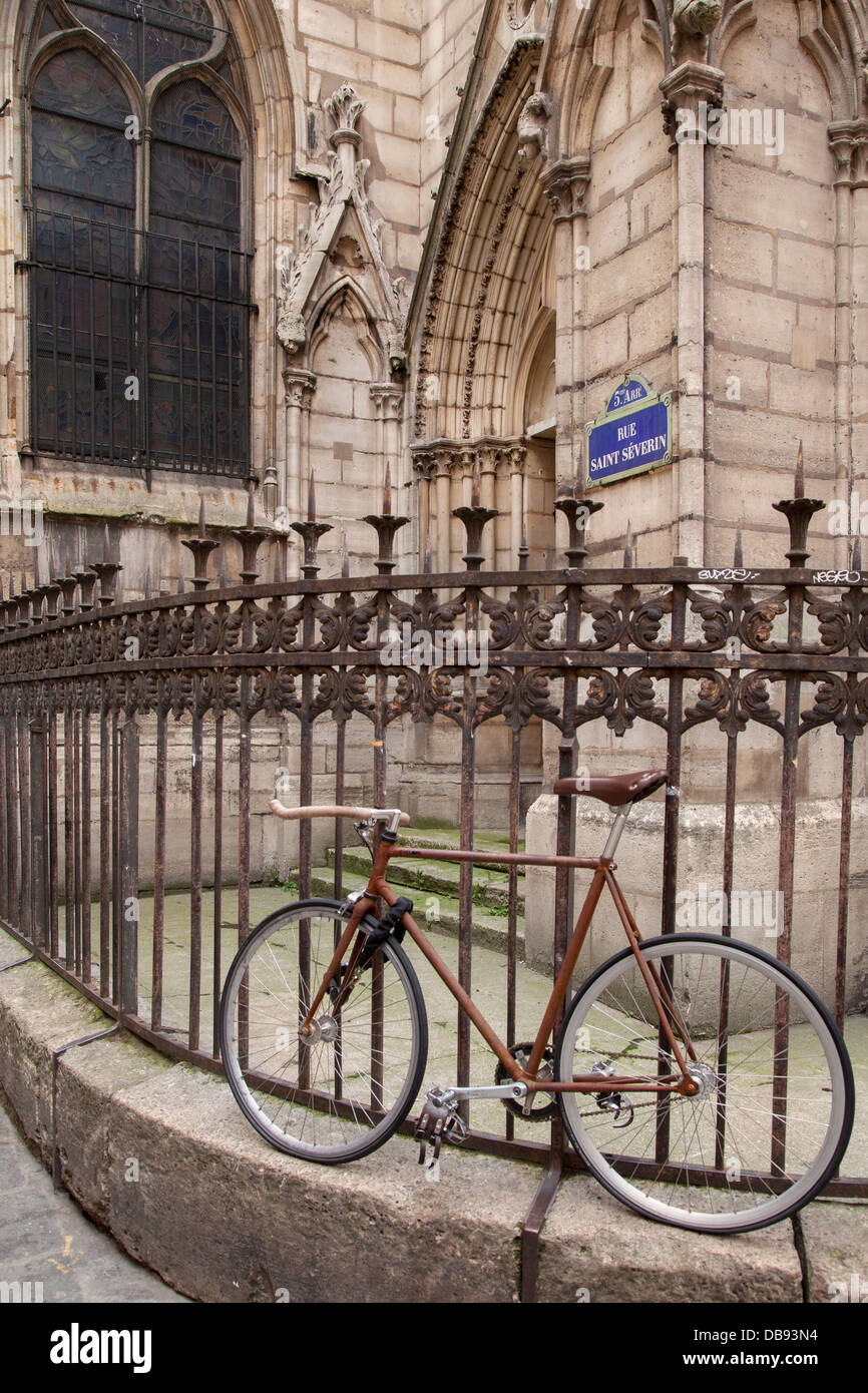 Bicycle chained to fence at Eglise Saint Severin in the Latin Quarter, Paris France Stock Photo