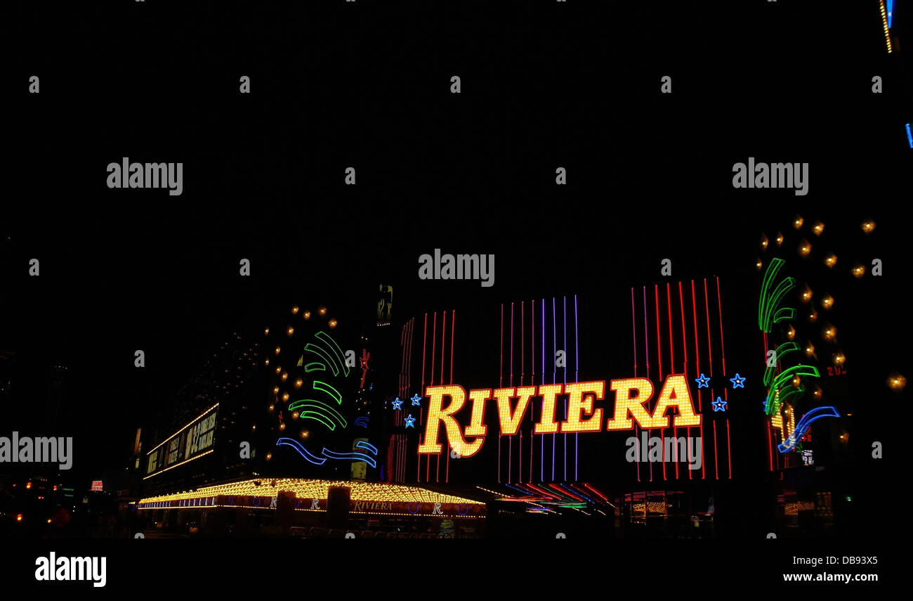Black sky night view red blue green stripes stars neon facade yellow name, Riviera Casino, to Circus Circus, Las Vegas Strip, US Stock Photo