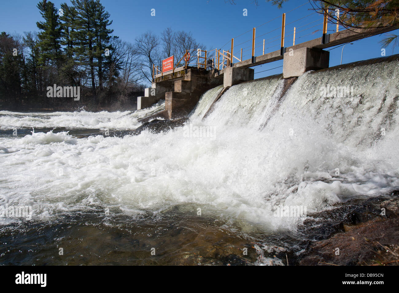 Water falls over the Norland Dam in the spring. Stock Photo