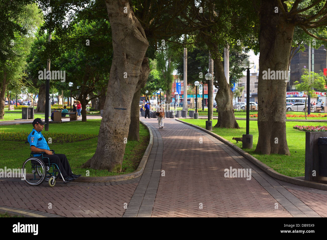Parque Kennedy with a handicapped Seguridad Ciudadana (Citizen Security Guard) in Miraflores, Lima, Peru Stock Photo