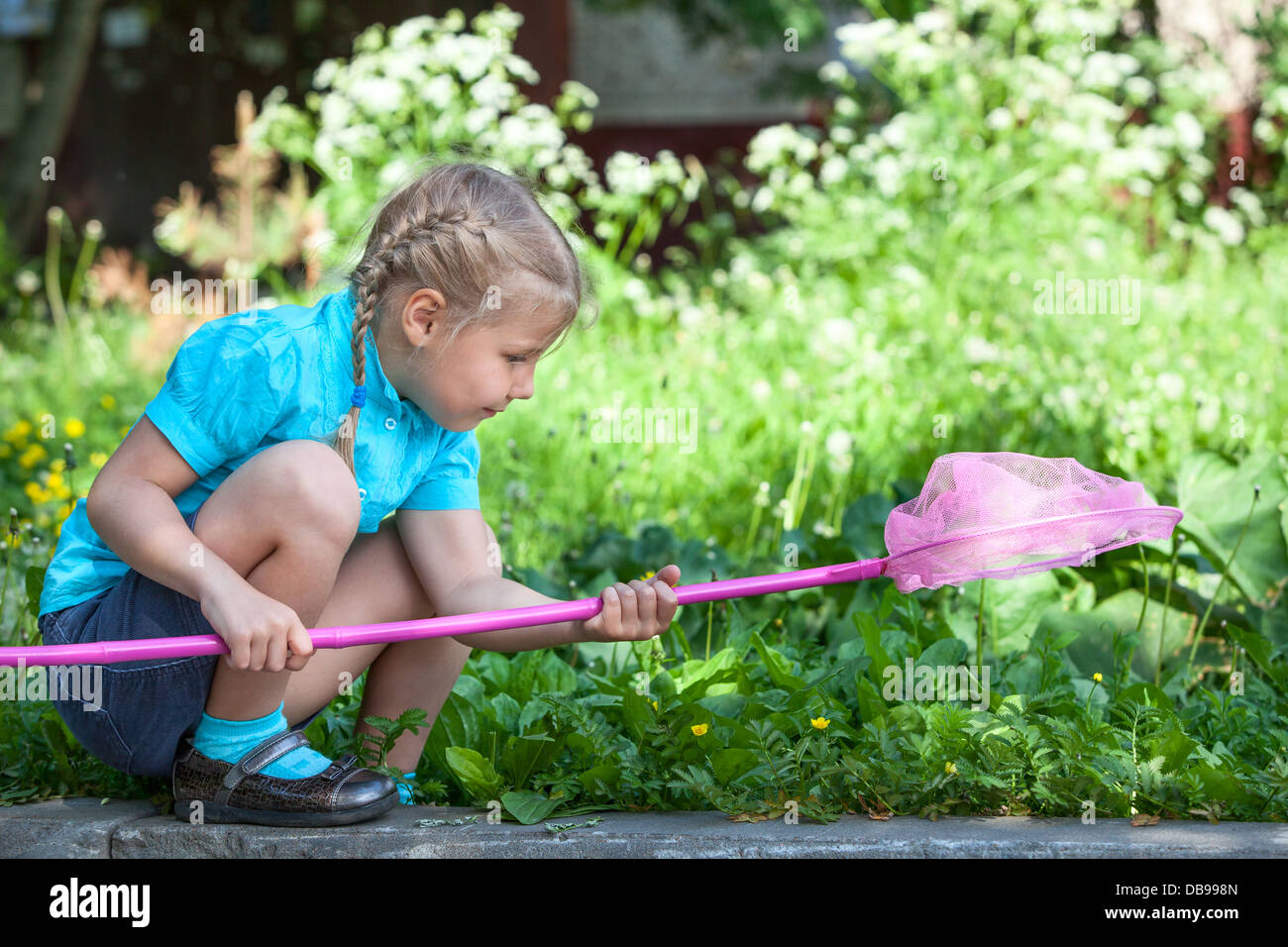 Children girl catching butterfly hi-res stock photography and