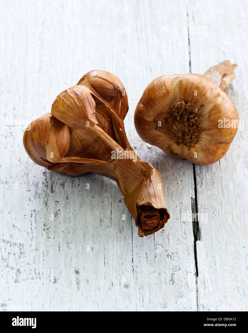Smoked Garlic on a wooden Kitchen Table Stock Photo