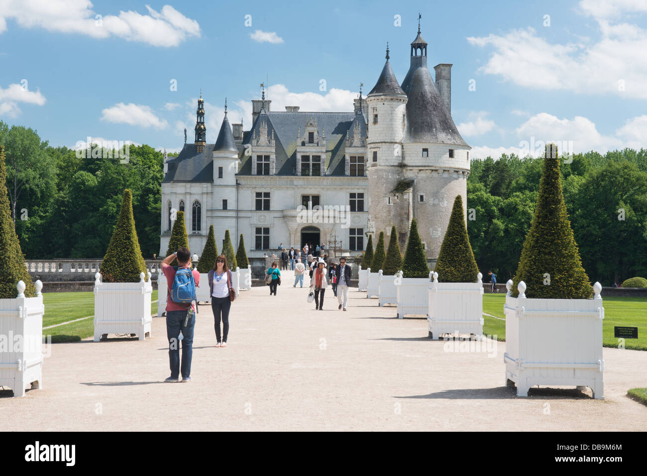 A landscape shot of tourists admiring Château Chenonceau in the Loire valley, France Stock Photo