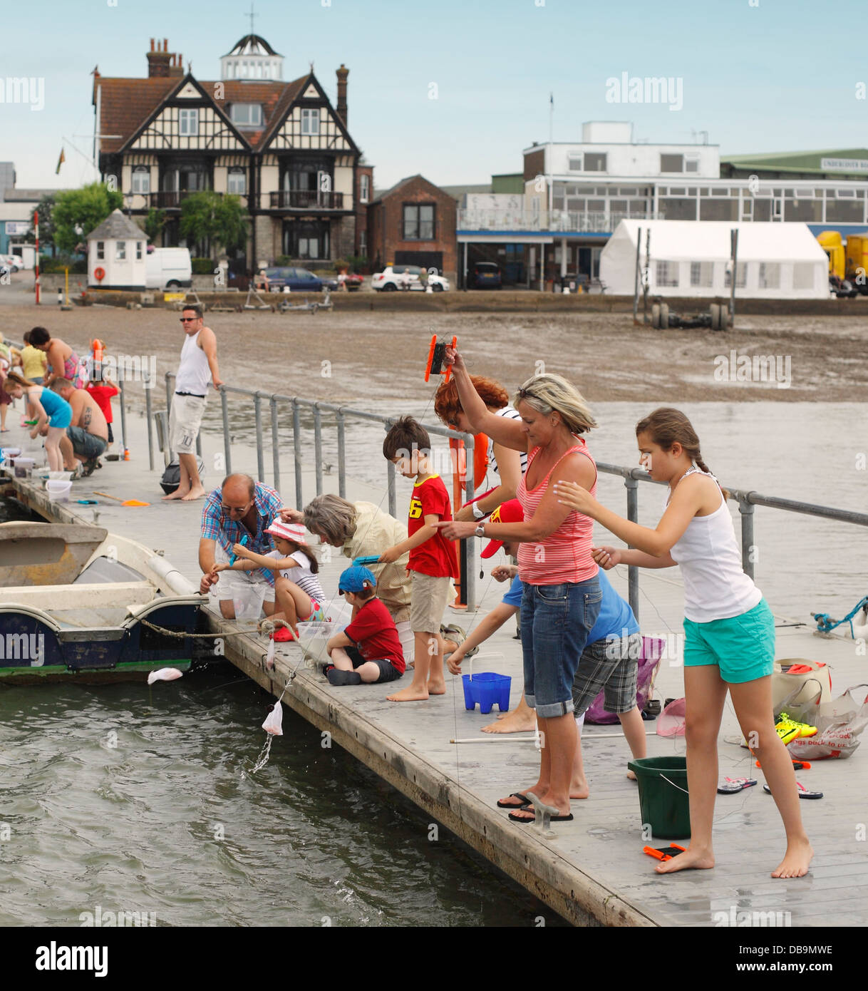 Families fishing for crabs at Brightlingsea Stock Photo Alamy