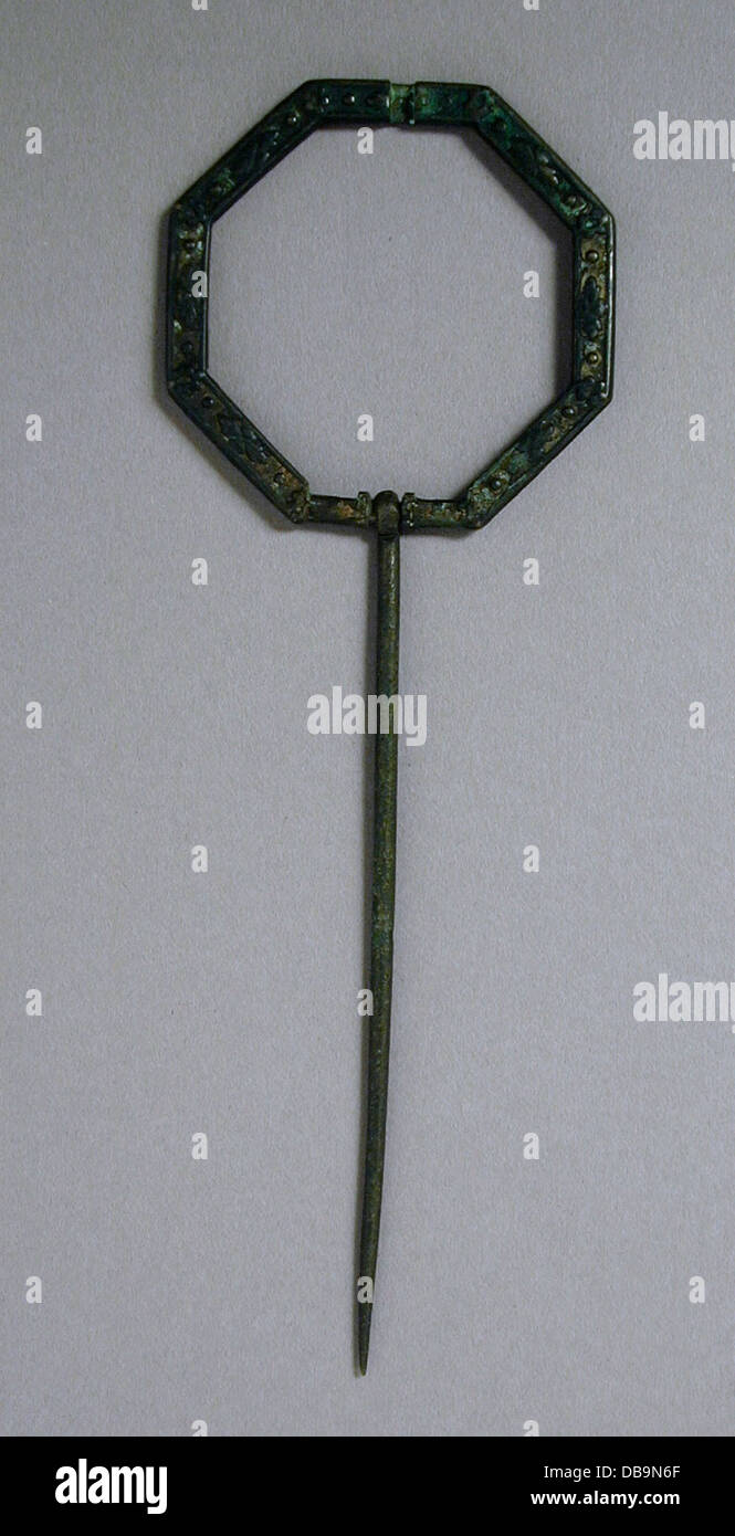 This penannular brooch is crafted from bronze, featuring a cast design ...