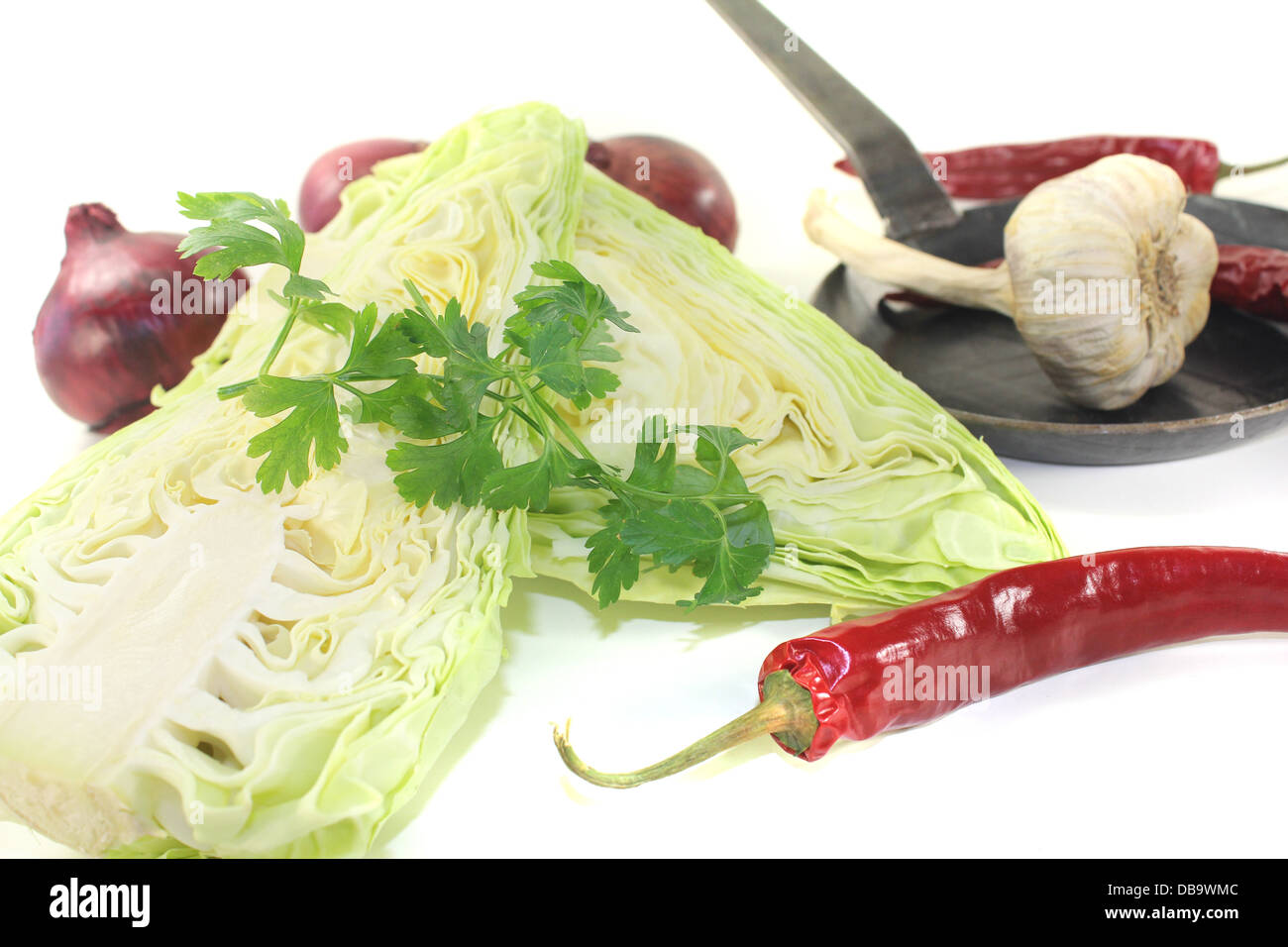 sweetheart cabbage with parsley and onions on a light background Stock Photo