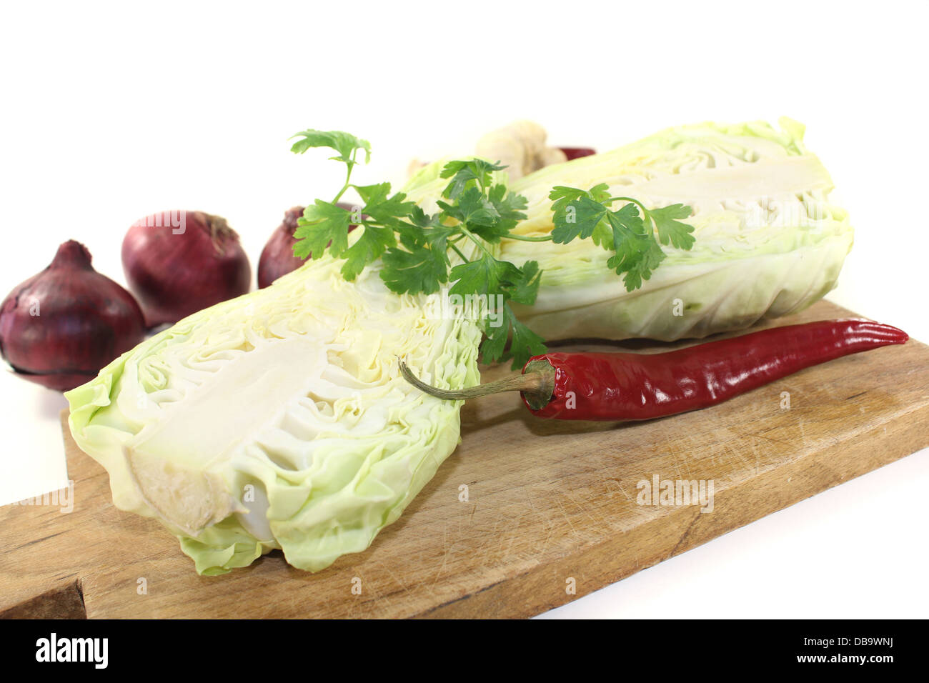 sweetheart cabbage with parsley, garlic and onions on a light background Stock Photo