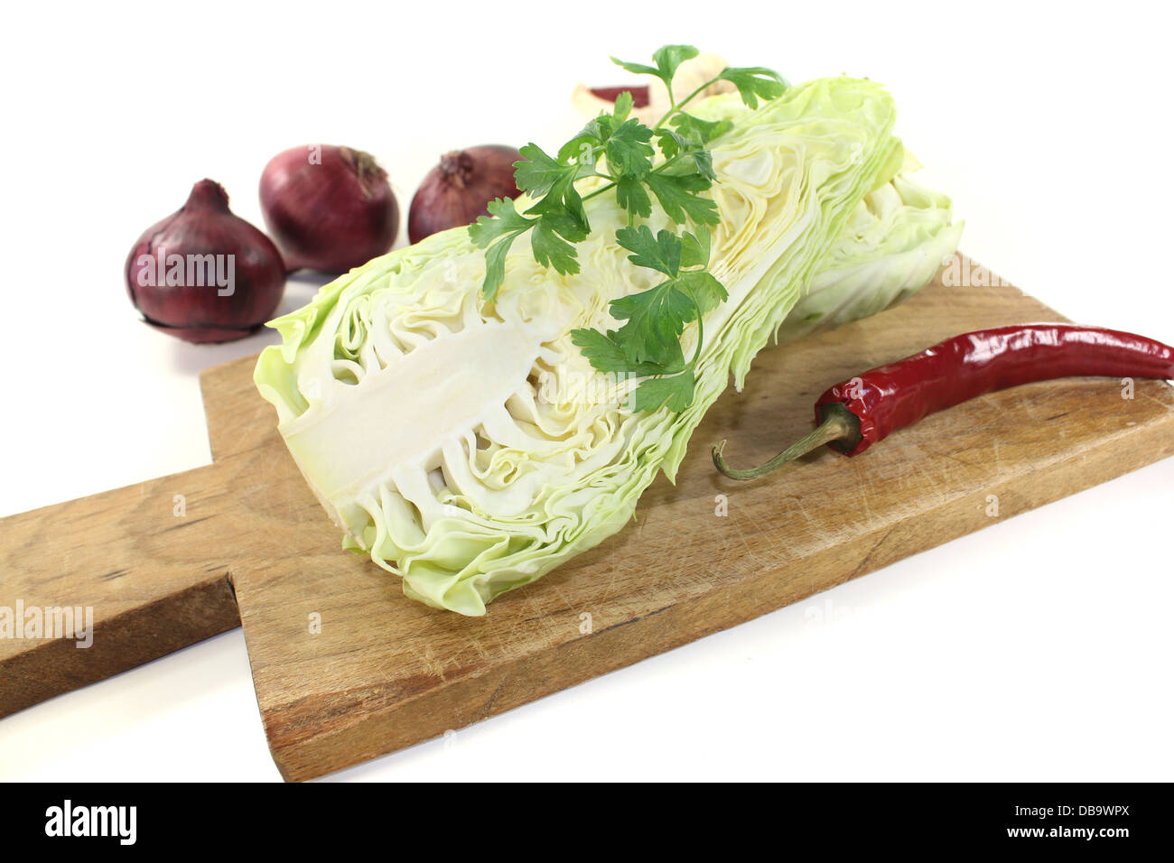 sweetheart cabbage with parsley, garlic, peppers and onions on a light background Stock Photo
