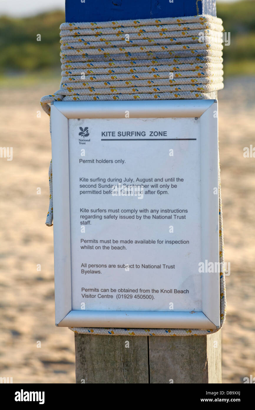 National Trust notice on post giving information about Kite Surfing Zone on beach at Studland in July Stock Photo