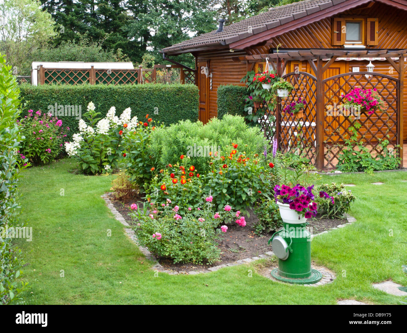 Wooden garden house and flower beds in an allotment garden Stock Photo