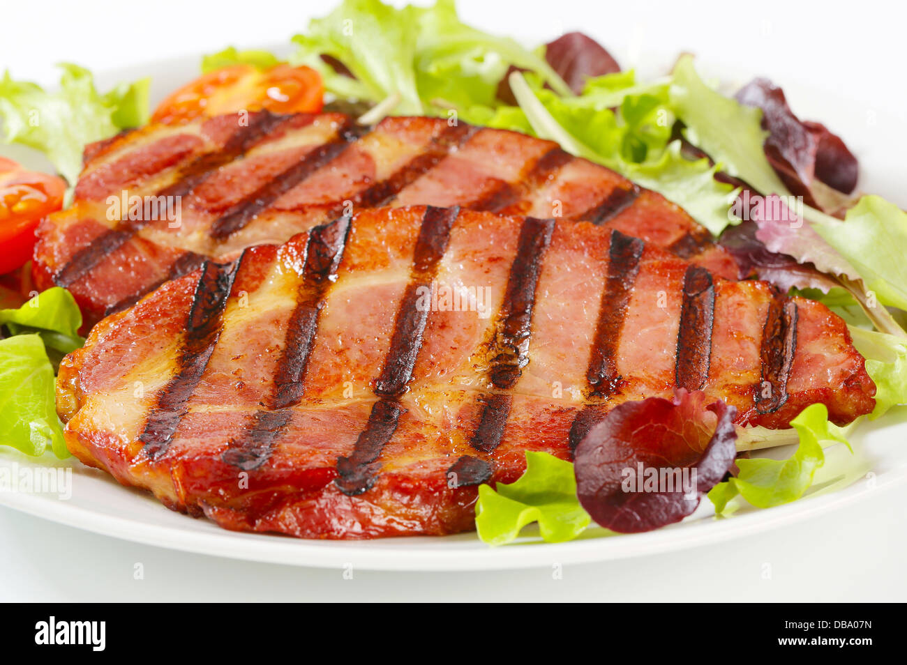 Grilled pork neck meat with salad greens Stock Photo