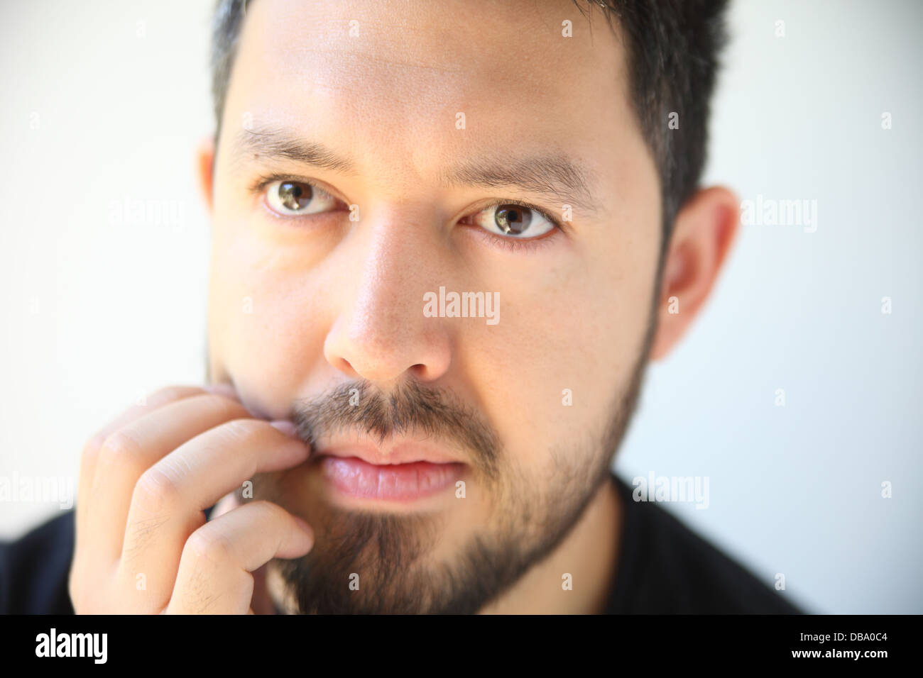 thirty-something man has an irritation in his beard Stock Photo
