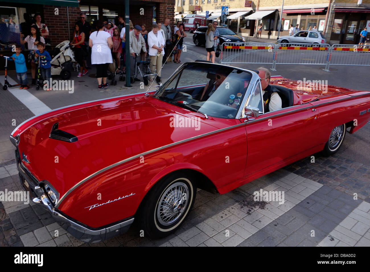 Two elderly men ride in the Red (1962) Ford Thunderbird Sports Roadster classic car. On the road in Varberg town, Sweden Stock Photo