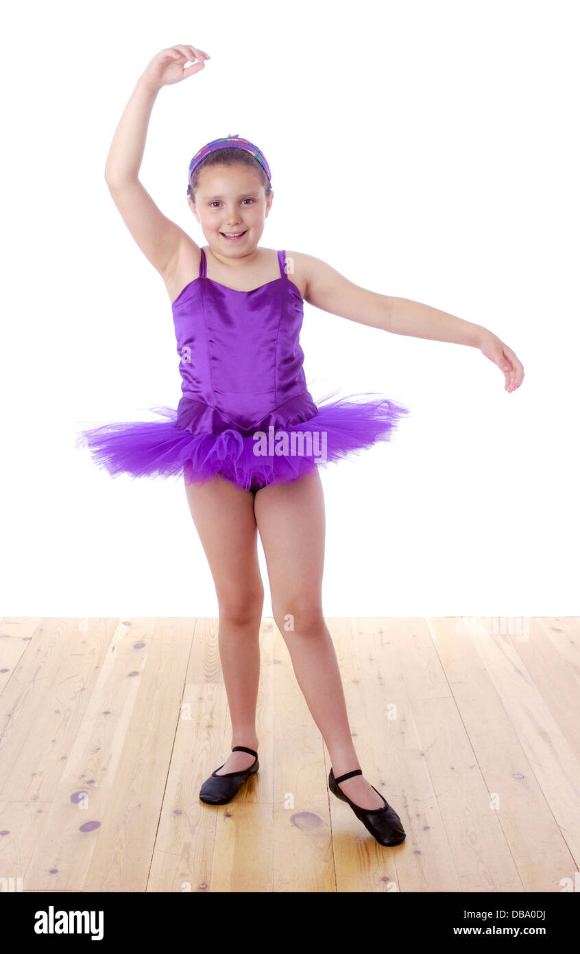 Young girl in purple tutu - ballet pose Stock Photo - Alamy