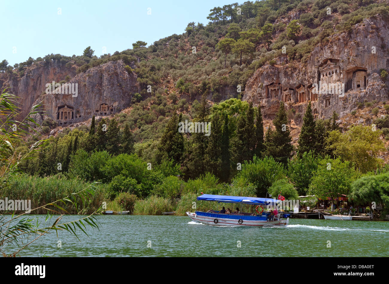 Rock tombs and tourist boat at the Dalyan river, Dalyan, Ortaca, Mugla, Turkey. Stock Photo