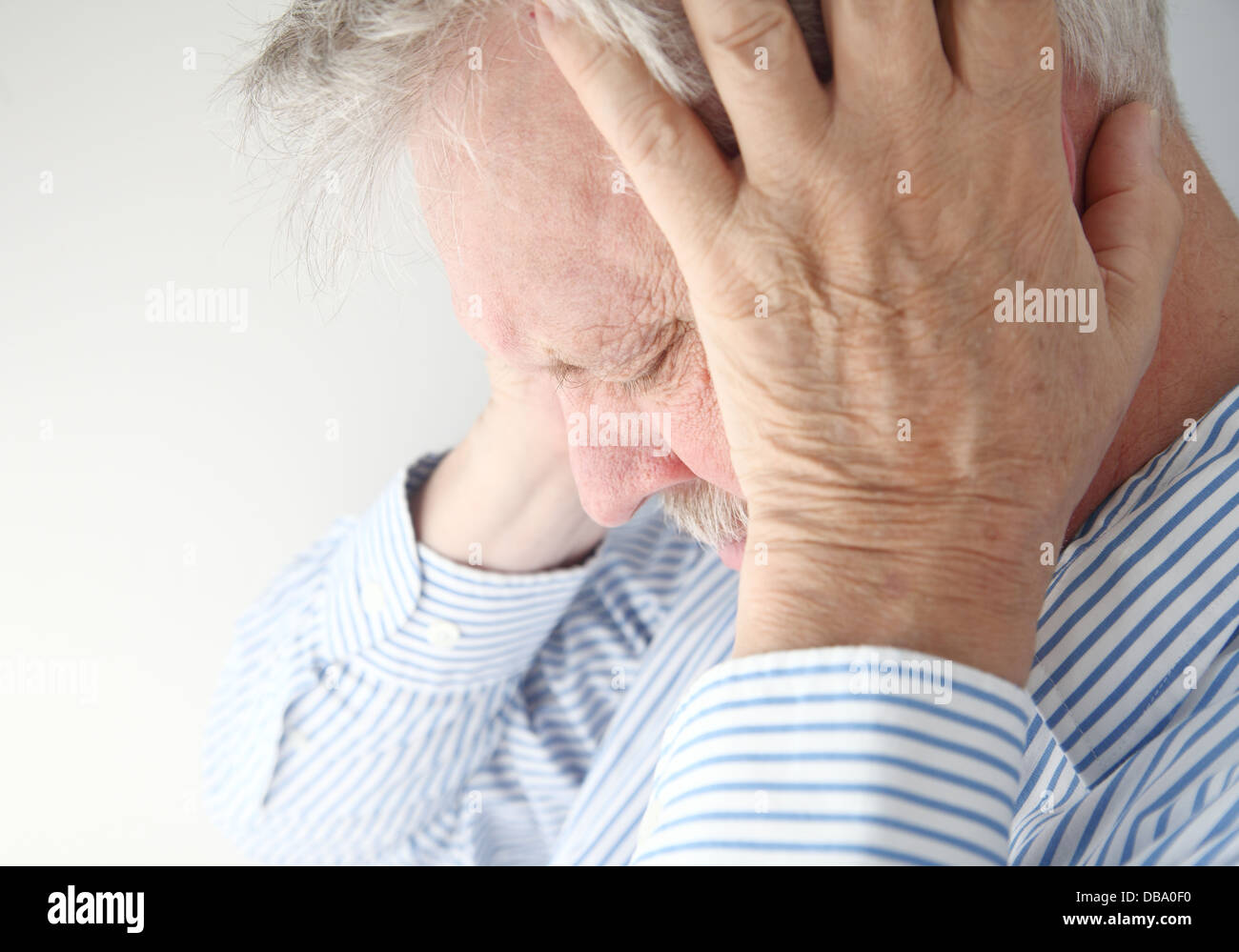 stressed older man holds his head in both hands Stock Photo - Alamy