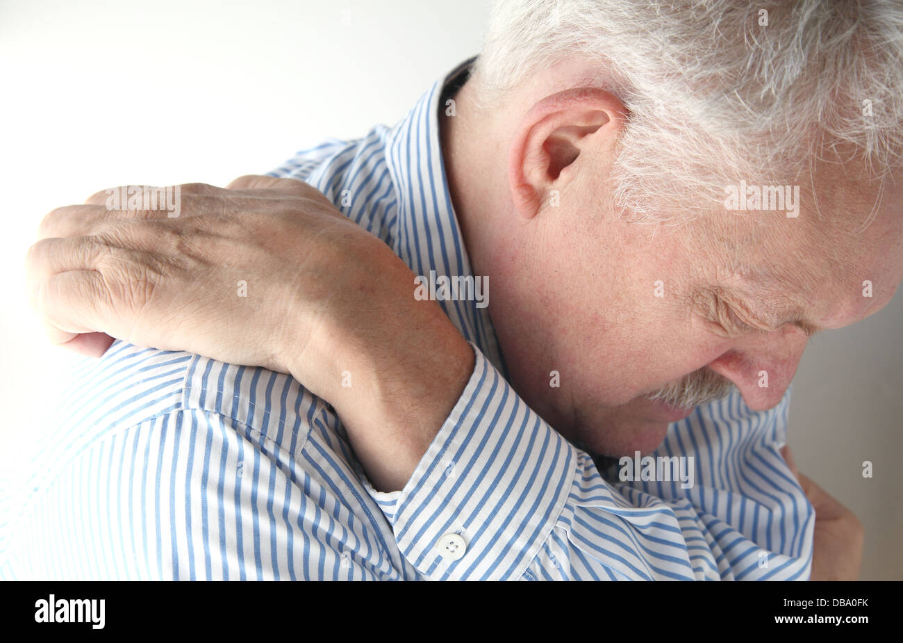 man stretches to reach an elusive itch Stock Photo