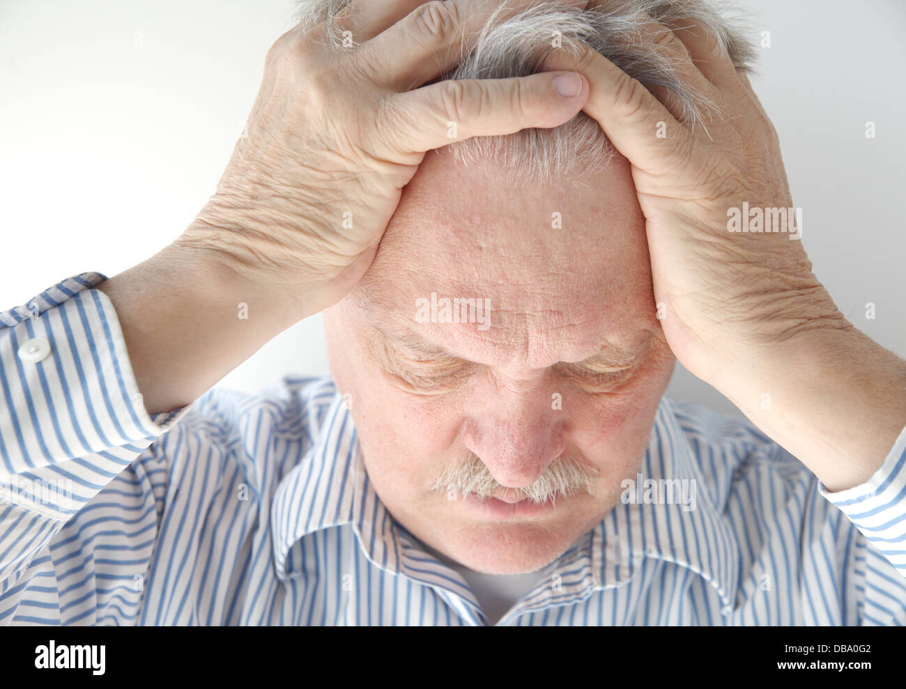 older man is overwhelmed and feeling pressure Stock Photo
