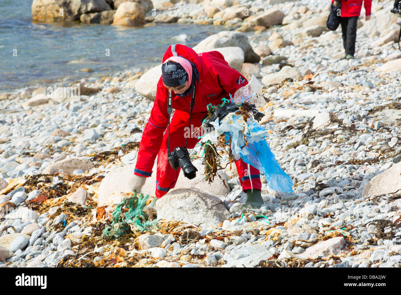 Tourist collect plastic rubbish on a remote beach in Northern Svalbard, only about 600 miles from the North Pole. Stock Photo