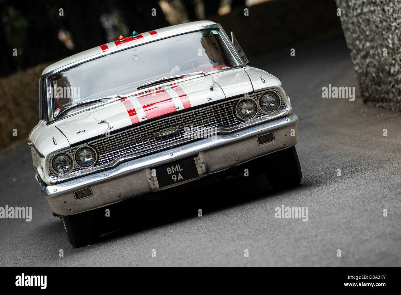 Chichester, UK - July 2013: Ford Galaxie 500 passes the flint wall in action at the Goodwood Festival of Speed on July 12, 2013. Stock Photo