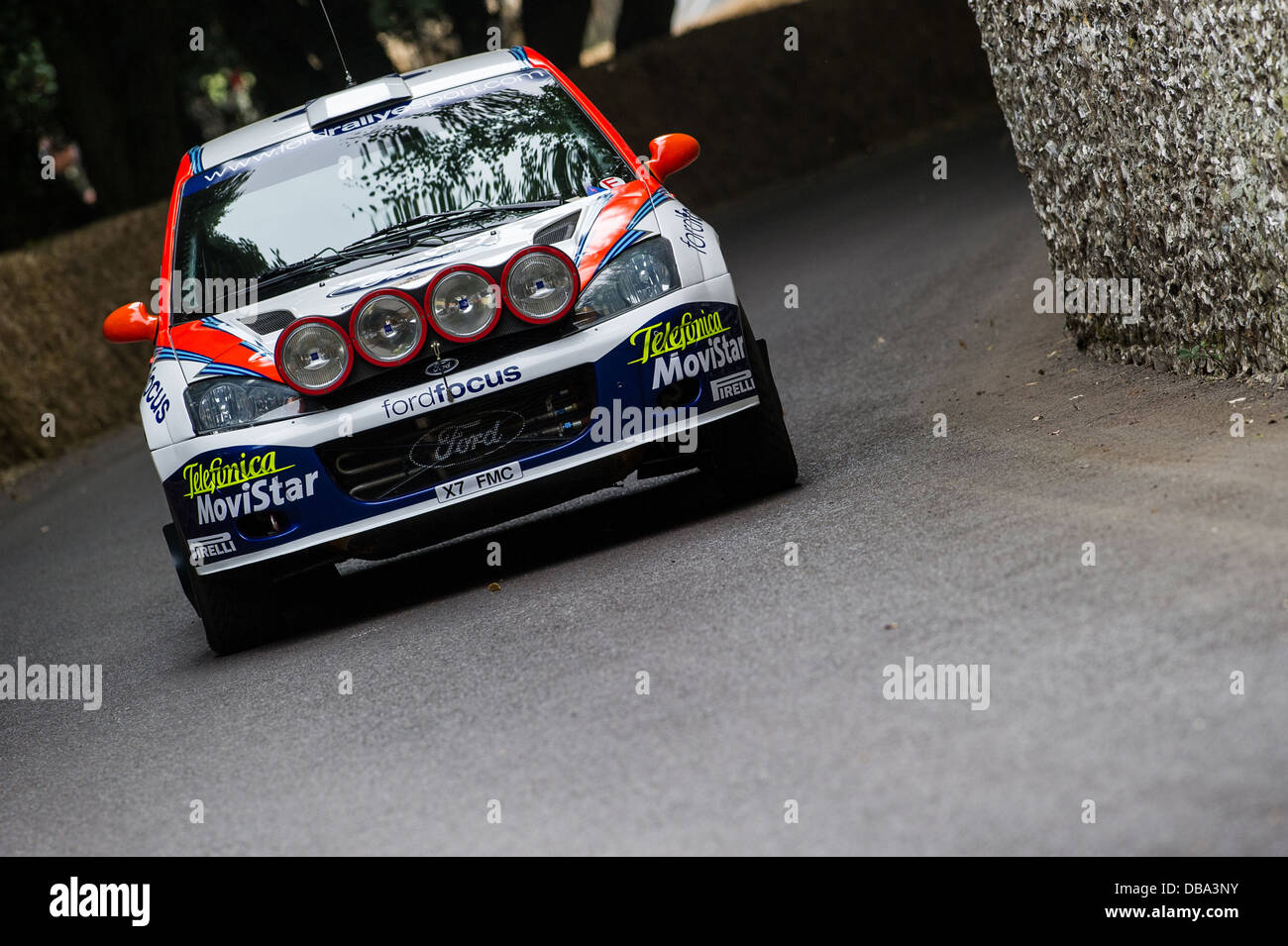 Chichester, UK - July 2013: Ford Focus WRC passes the flint wall in action at the Goodwood Festival of Speed on July 12, 2013. Stock Photo