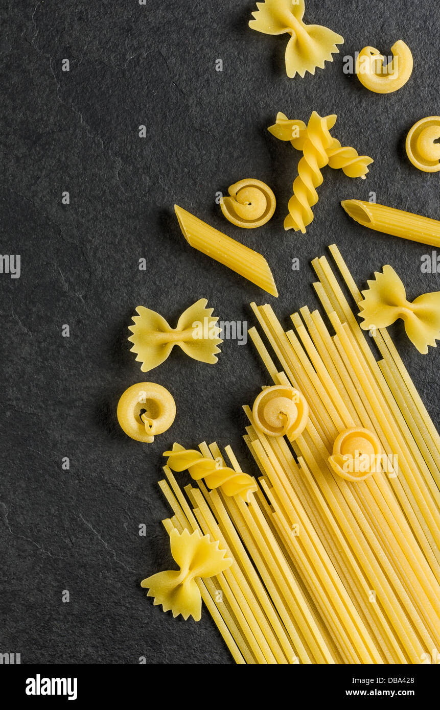 Different types of pasta on a slate background Stock Photo