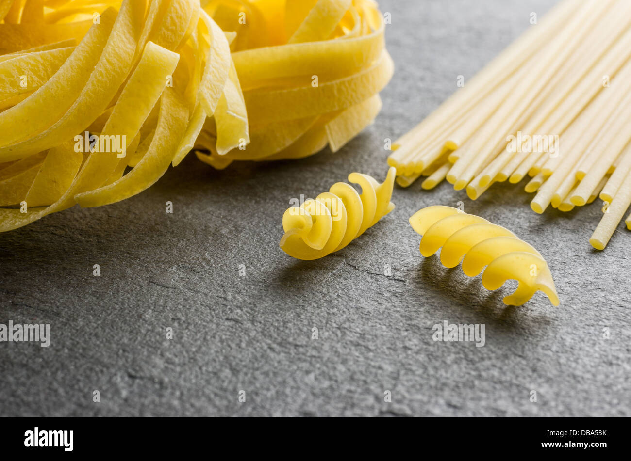 Different types of pasta on a slate background Stock Photo