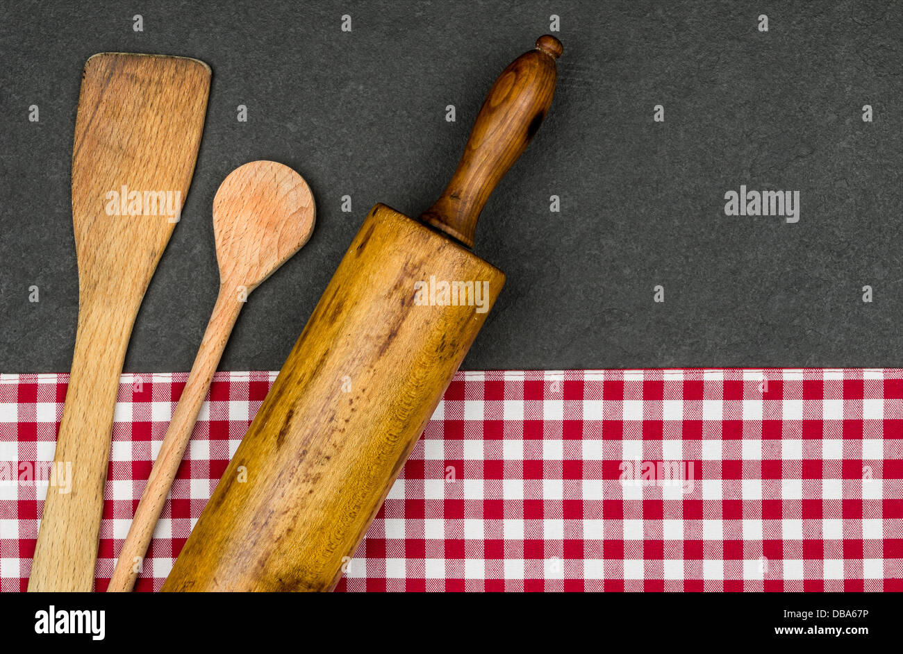 Rolling pin with wooden spoon on a slate plate Stock Photo