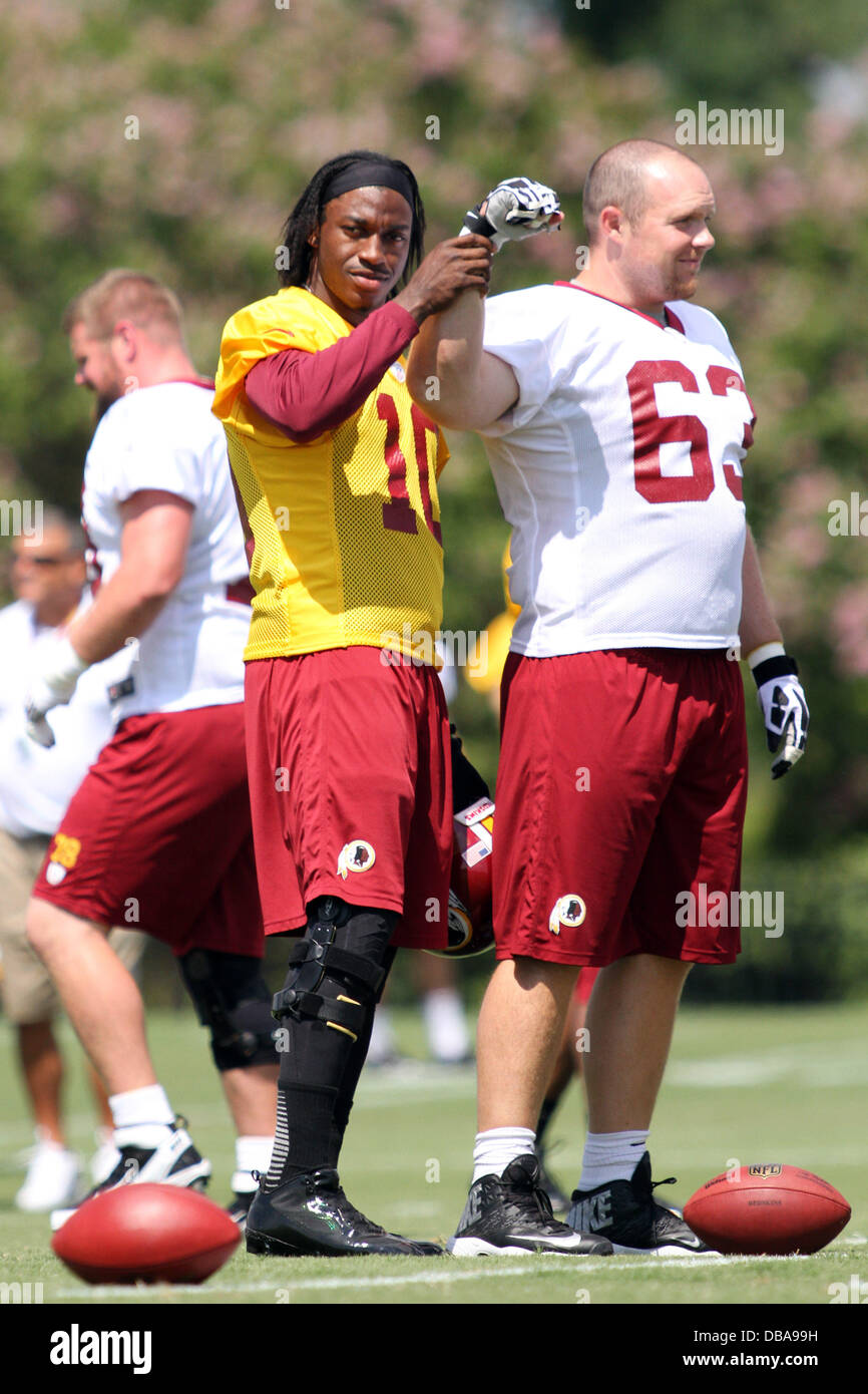 Richmond, Virginia, USA. 26th July, 2013. July 26, 2013: Washington Redskins #10 Robert Griffin III roots for the Redskins by using Washington Redskins #63 Will Montgomery's arm in support at the Bon Secours training facility in Richmond, Virginia. Daniel Kucin Jr./ CSM/Alamy Live News Stock Photo