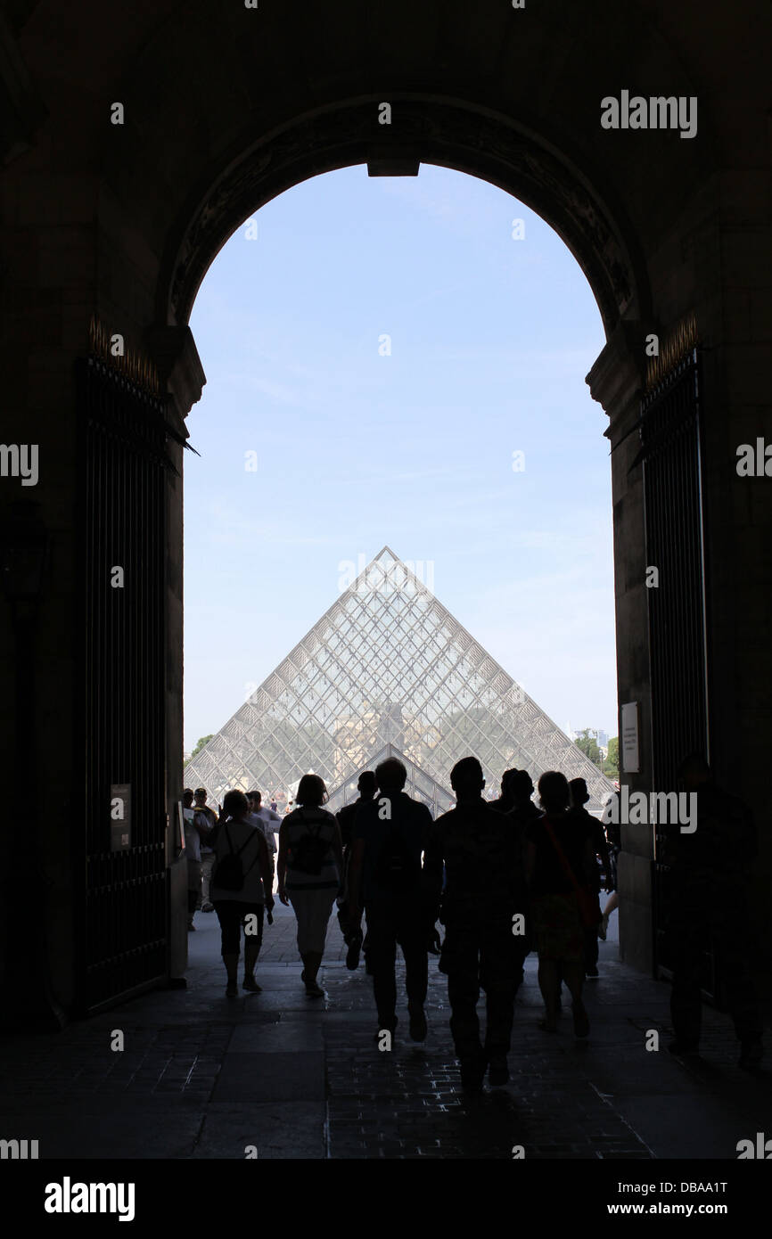Looking westwards towards Pyramide du Louvre from beneath an archway.  Louvre Palace, Paris, France Stock Photo
