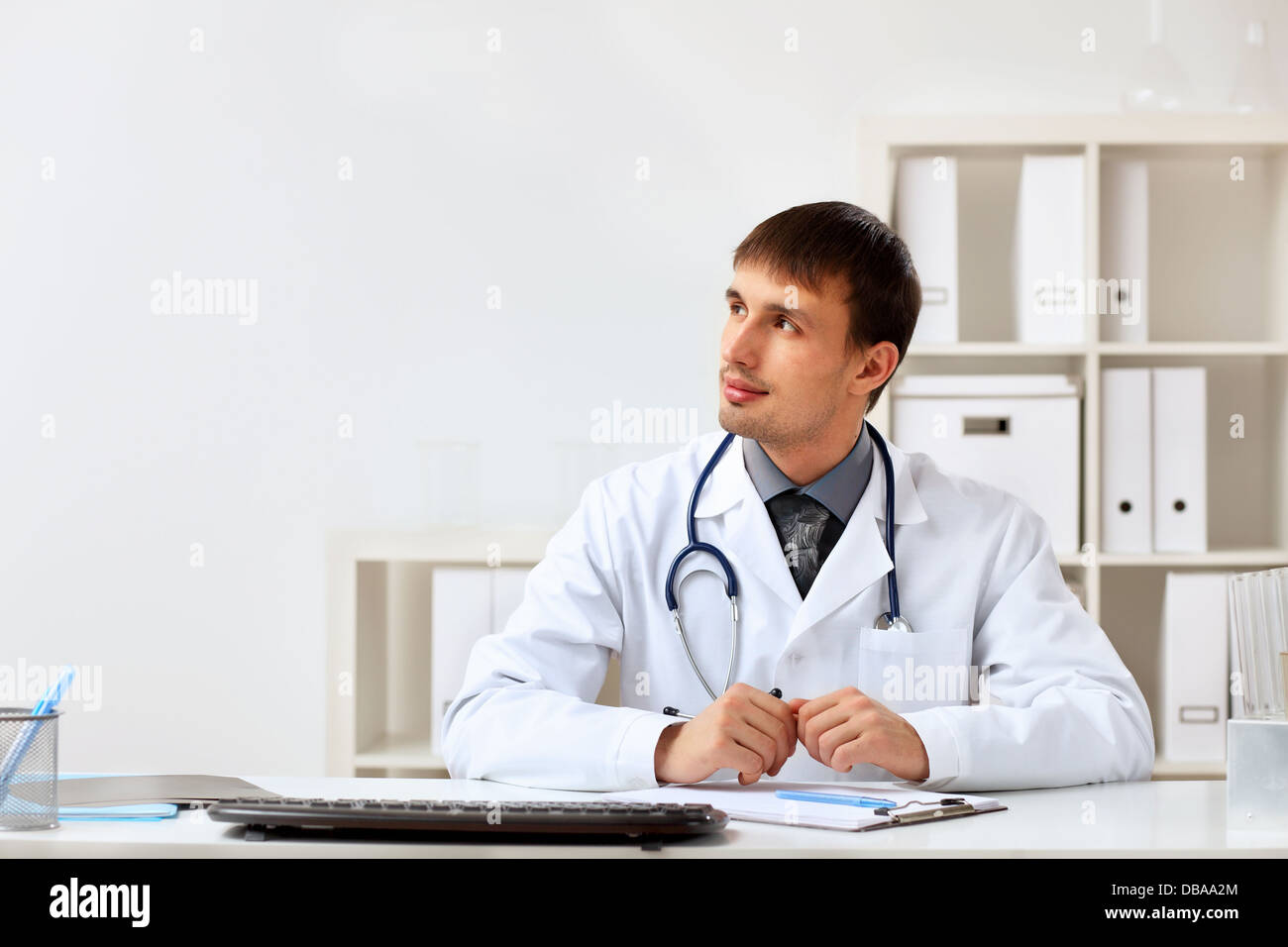 Young male doctor in white uniform Stock Photo - Alamy