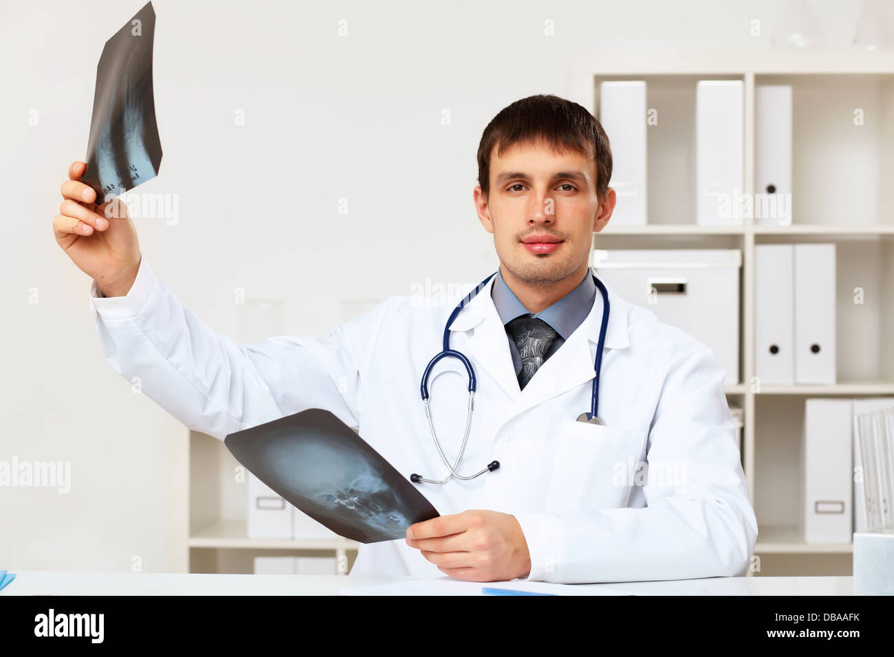 Young male doctor in white uniform Stock Photo - Alamy