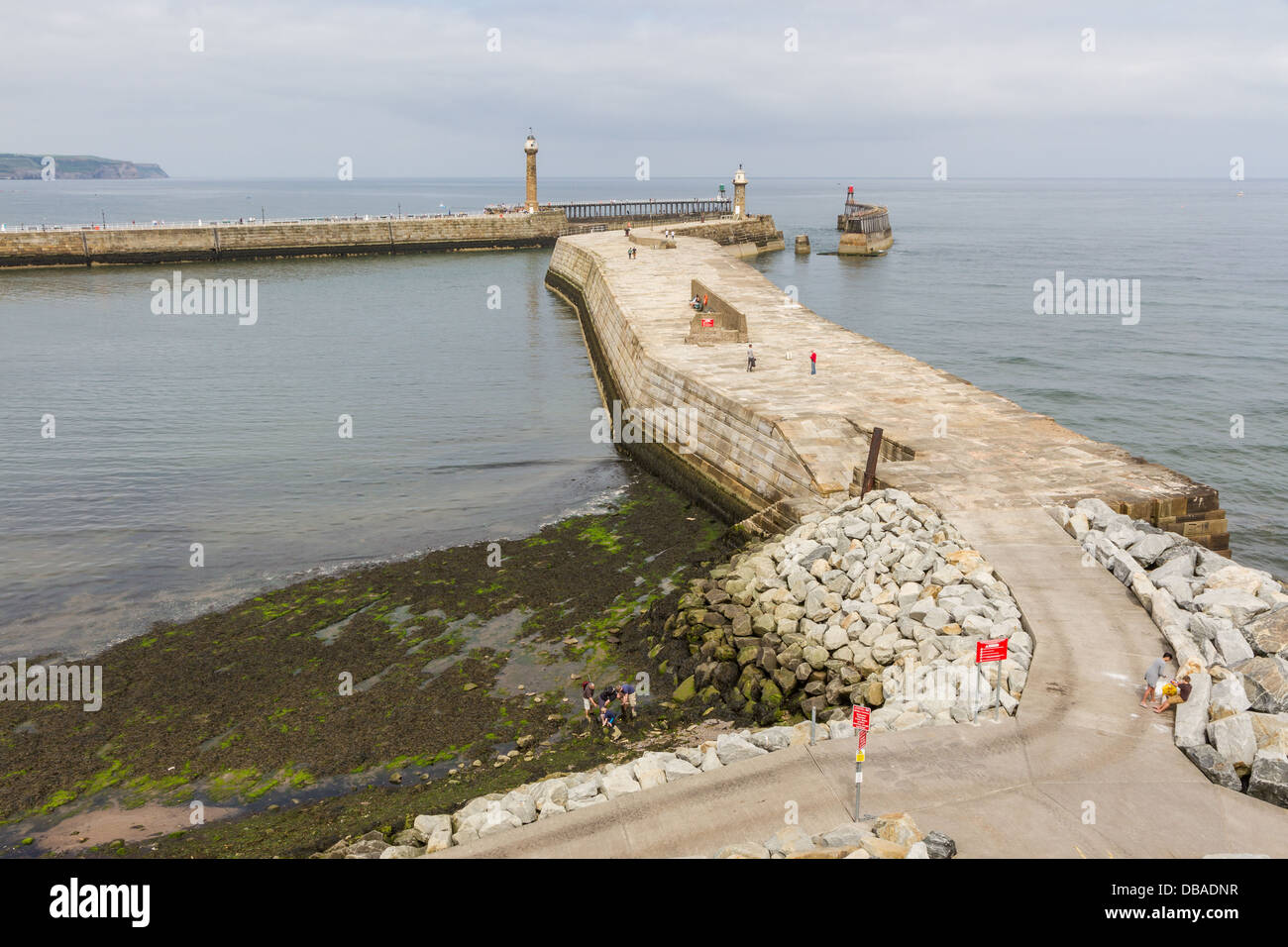 Whitby harbour wall and east and west pier with lighthouses Stock Photo