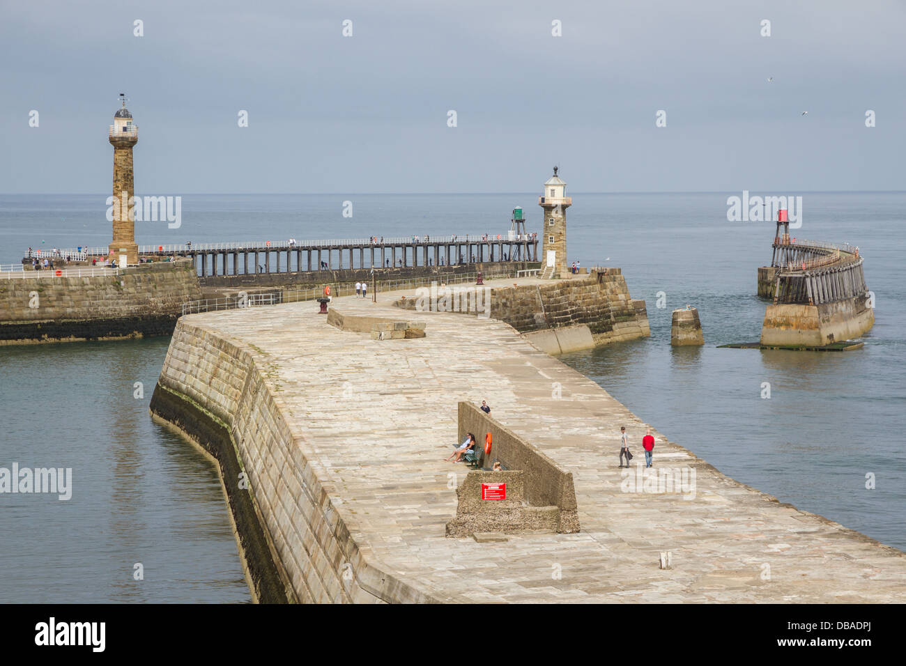 Whitby harbour wall and east and west pier with lighthouses Stock Photo