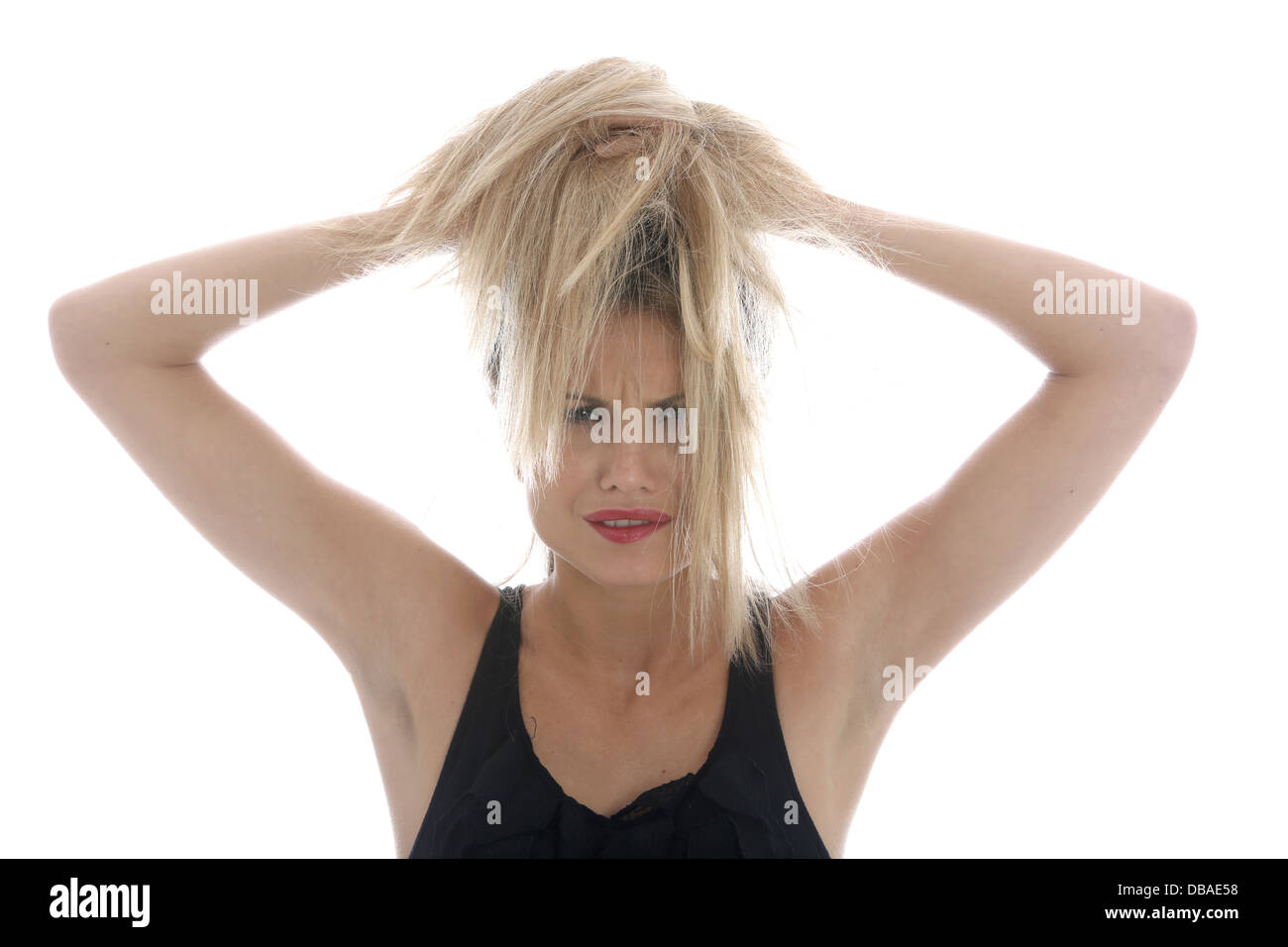 Model Released. Angry Frustrated Young Woman Pulling Hair Stock Photo