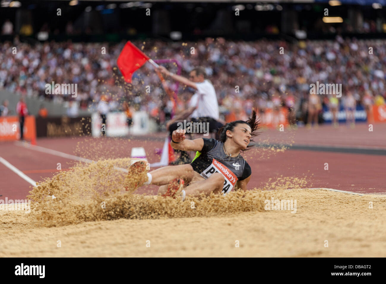 London, UK. 26th July, Athanasia Perra in action at the womens triple jump event, red flagged, Anniversary Games British Athletics, London. 2013. Photo: Credit: Rebecca Andrews/Alamy Live News Stock Photo