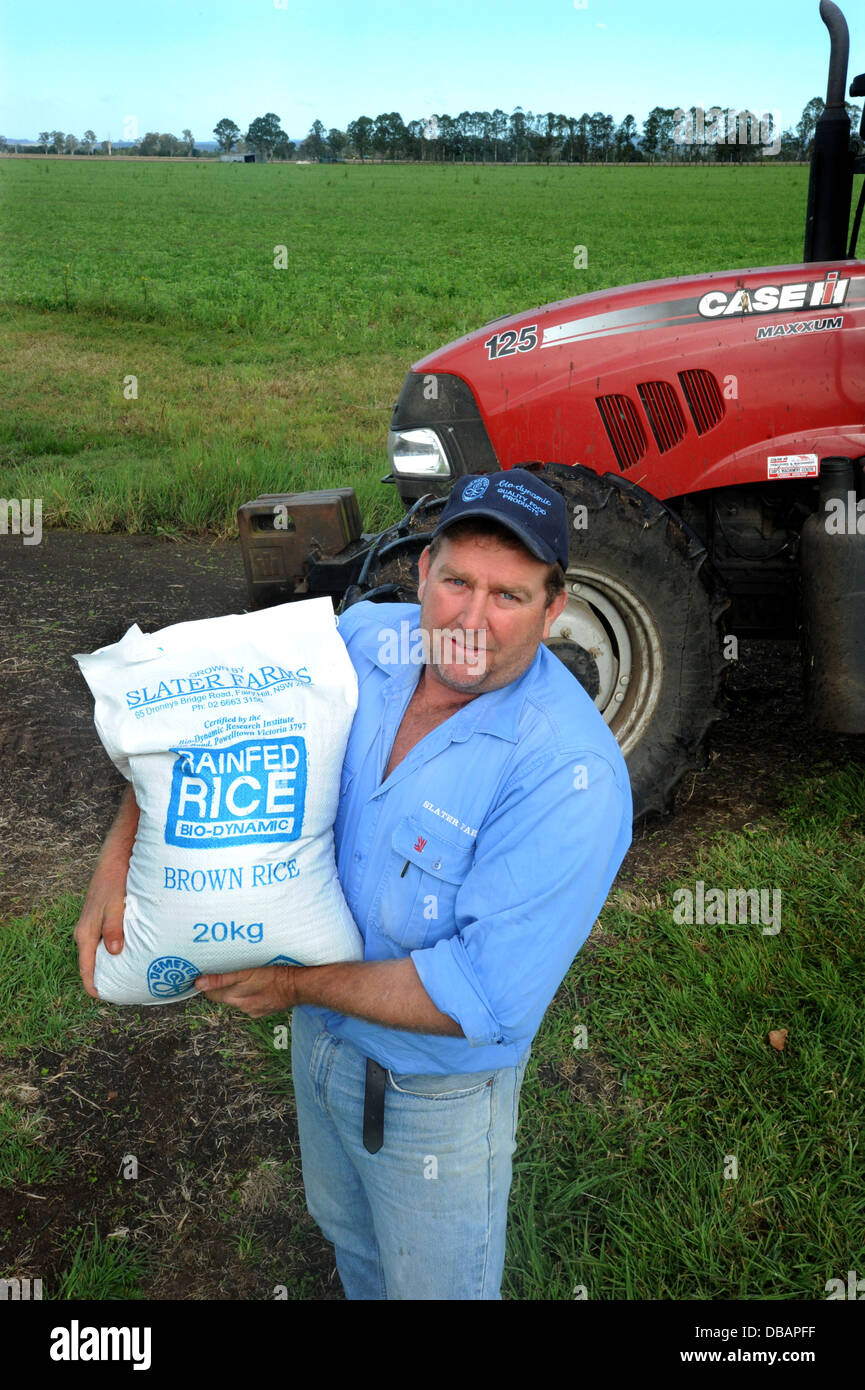 Byodynamic farmer with brown rice grown NSW Australia Stock Photo