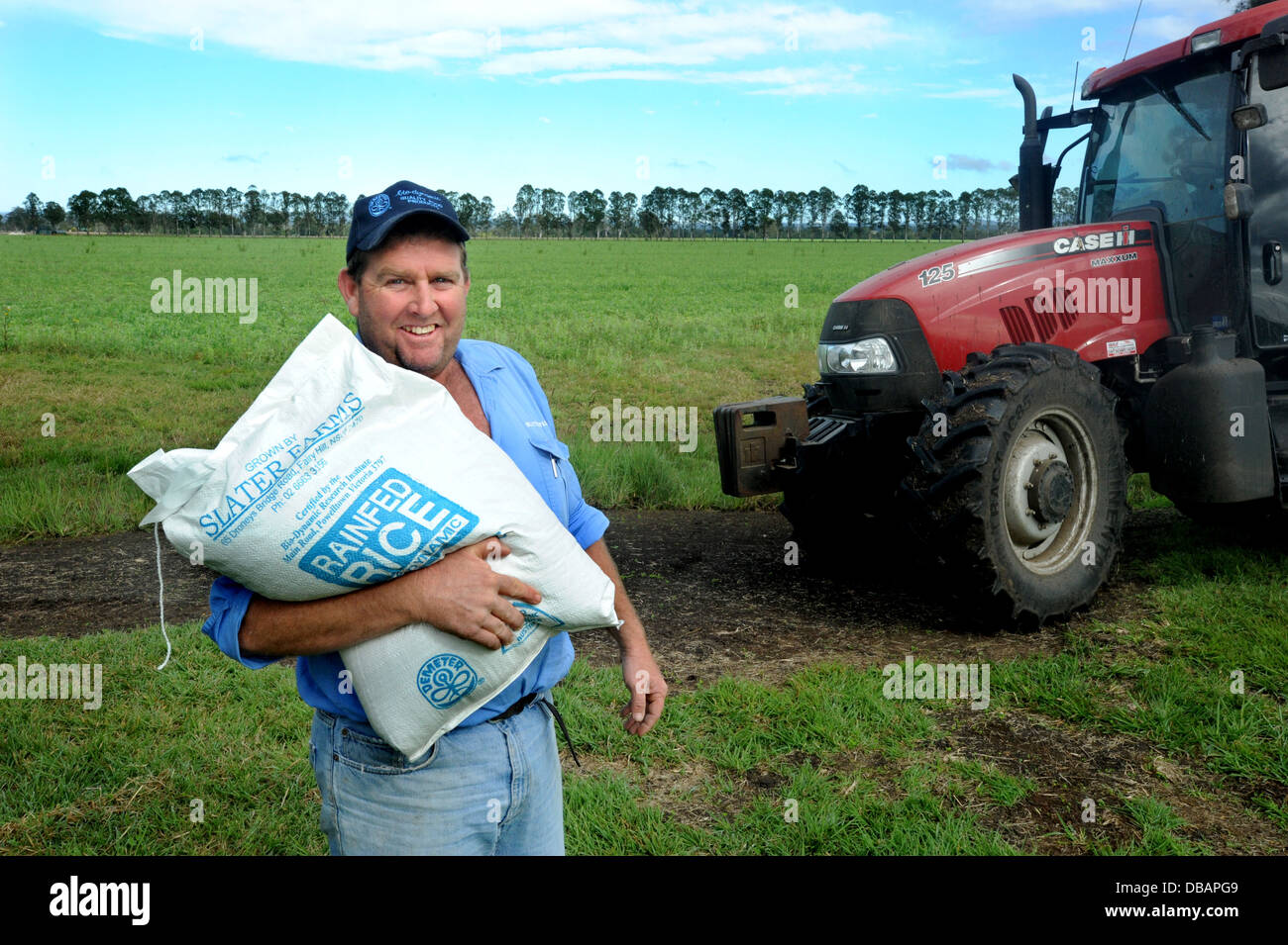 Byodynamic farmer with brown rice grown NSW Australia Stock Photo