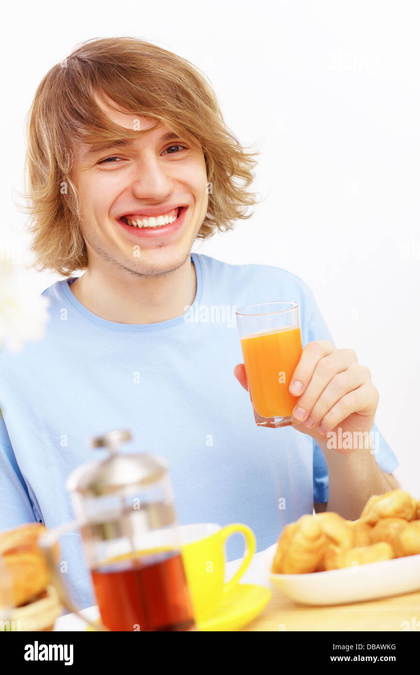 Young man drinking juice Stock Photo Alamy